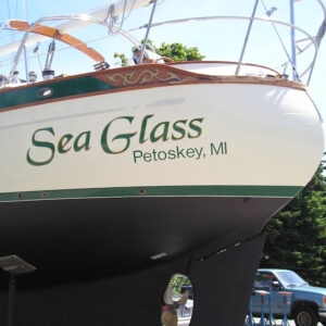 Large cut vinyl boat name applied to the hull of a sailboat.